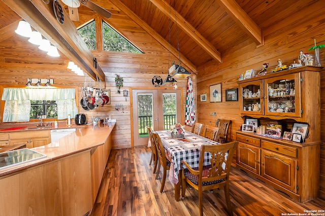 dining room featuring dark hardwood / wood-style flooring, plenty of natural light, and wood walls