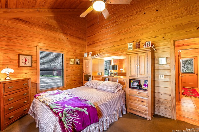 bedroom featuring wood ceiling, ceiling fan, dark colored carpet, high vaulted ceiling, and beamed ceiling