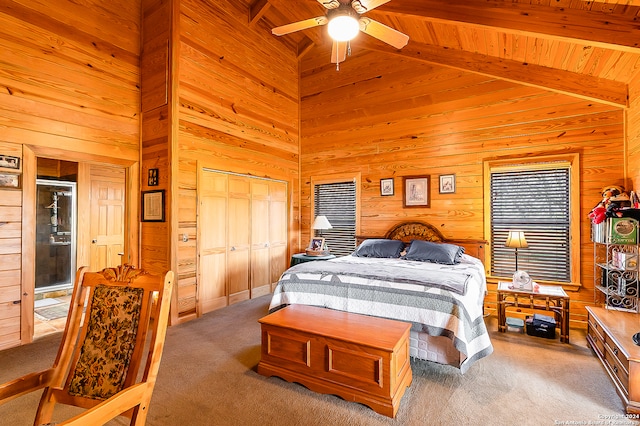 bedroom with carpet flooring, ceiling fan, beam ceiling, and a closet