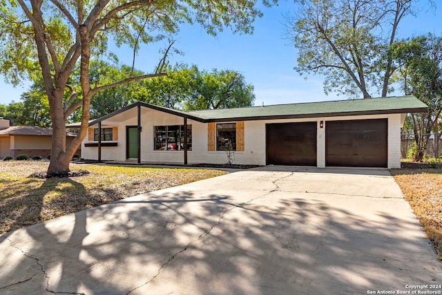 ranch-style house featuring a garage