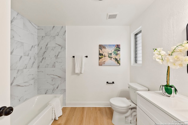 bathroom featuring toilet, vanity, and wood-type flooring