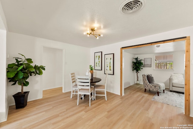 dining room featuring a chandelier and light hardwood / wood-style flooring