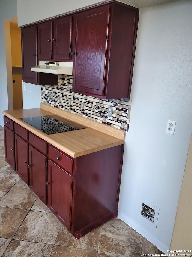 kitchen featuring black electric stovetop and backsplash