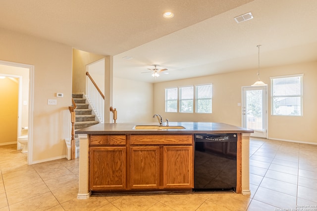 kitchen with dishwasher, hanging light fixtures, a healthy amount of sunlight, and a center island with sink