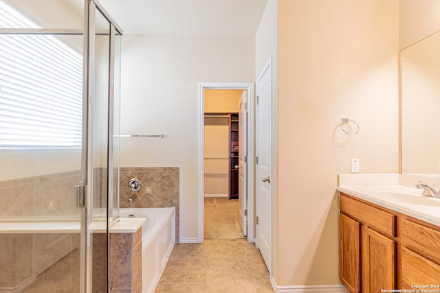 bathroom featuring tile patterned flooring, vanity, and independent shower and bath