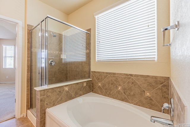 bathroom featuring plus walk in shower