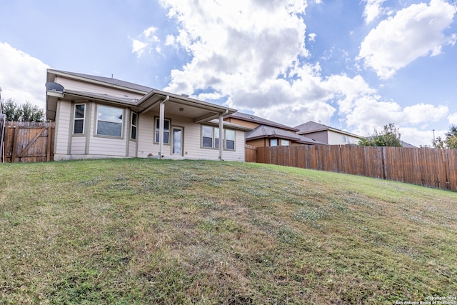 rear view of house with a lawn