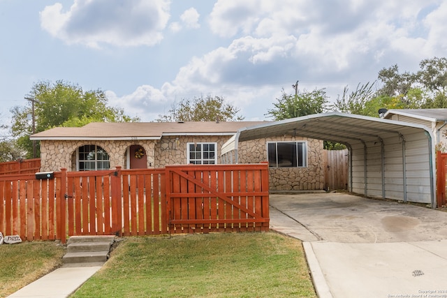 view of front of property with a front yard and a carport