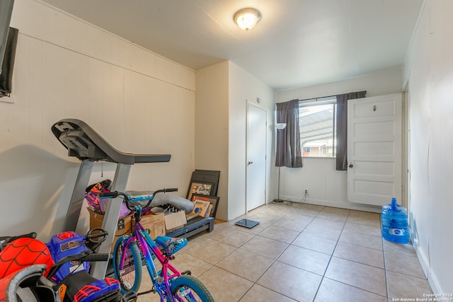 workout area featuring light tile patterned floors