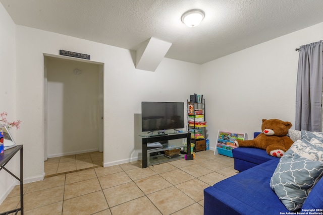 living room featuring tile patterned floors and a textured ceiling