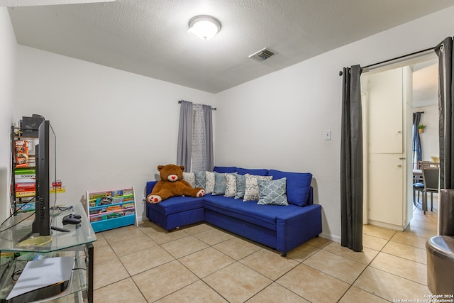 tiled living room with a textured ceiling