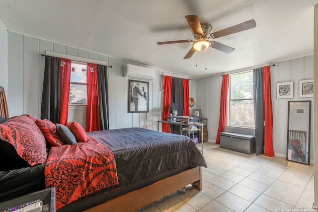 tiled bedroom with multiple windows, ceiling fan, and a wall mounted air conditioner