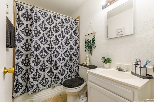 full bathroom with shower / bath combo with shower curtain, tile patterned floors, vanity, and toilet