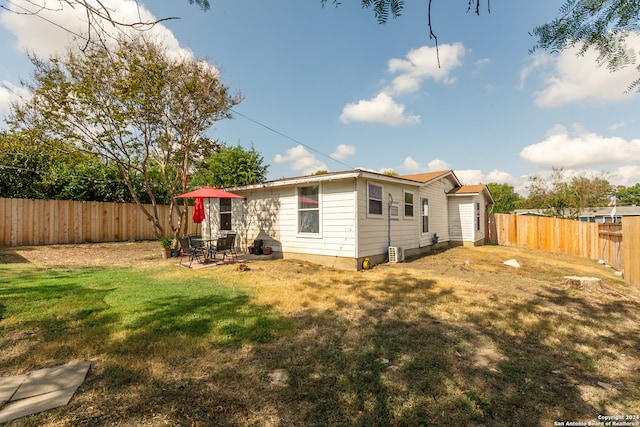 back of property with a patio and a yard