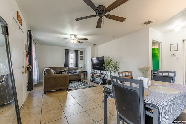 dining room featuring a textured ceiling, tile patterned flooring, and ceiling fan