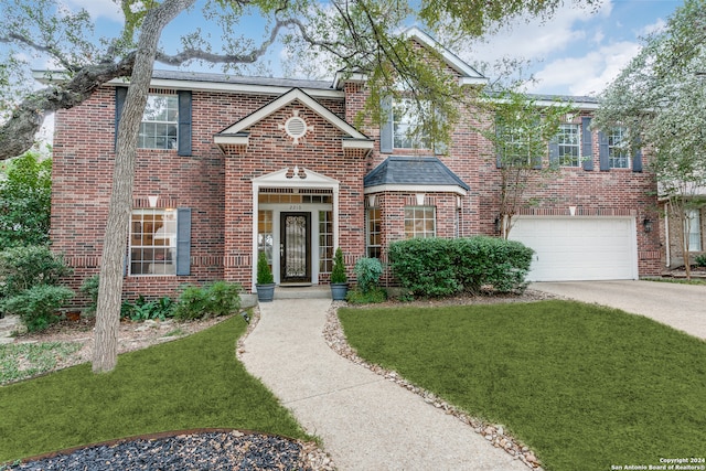 view of front facade with a garage and a front yard