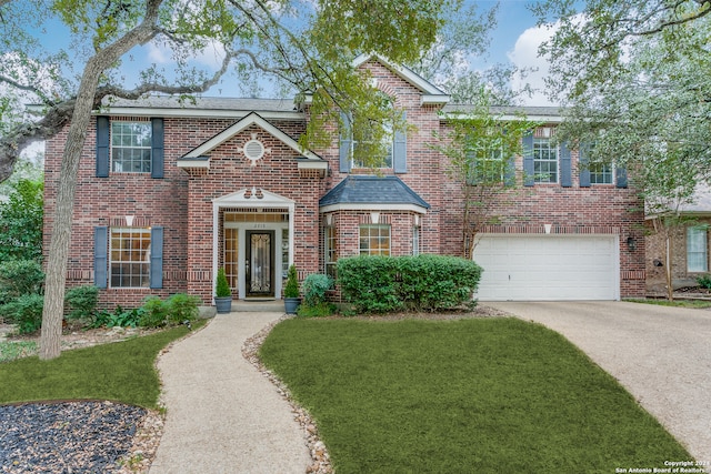 view of front facade with a garage and a front lawn