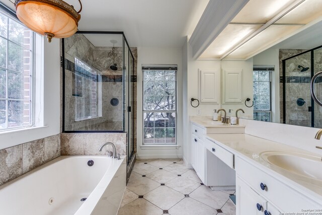 bathroom with vanity and shower with separate bathtub