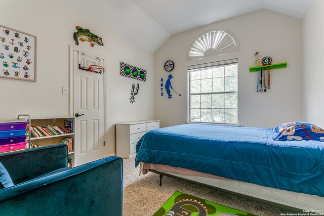 carpeted bedroom with vaulted ceiling