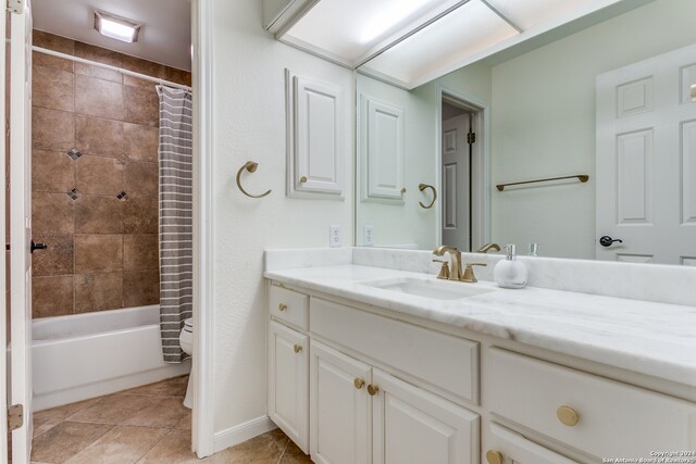 bathroom featuring vanity, tile patterned flooring, and shower / bathtub combination with curtain