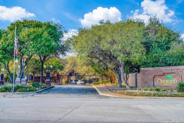 2210 Postoak Ct, San Antonio, TX 78248 - view of asphalt street featuring curbs, a gated entry, sidewalks, and a gate