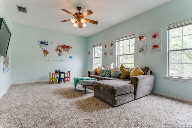 interior space with ceiling fan