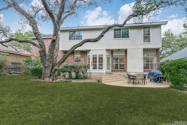 back of house featuring a yard and a patio area