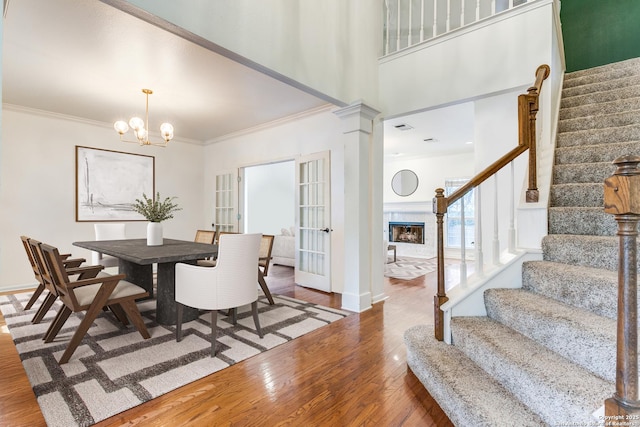 2210 Postoak Ct, San Antonio, TX 78248 - dining room with stairs, wood finished floors, a high end fireplace, a chandelier, and ornamental molding