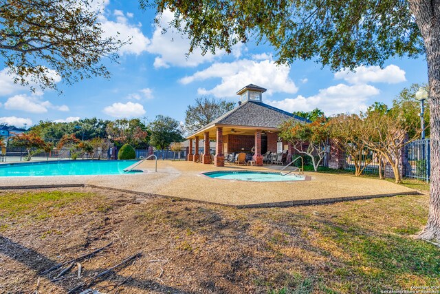 view of pool with ceiling fan and a patio