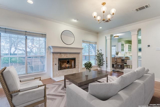 2210 Postoak Ct, San Antonio, TX 78248 - living room with ornate columns, baseboards, ornamental molding, a tile fireplace, and a chandelier