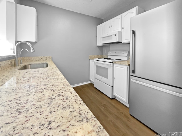 kitchen featuring dark wood-type flooring, sink, light stone countertops, white cabinetry, and white appliances