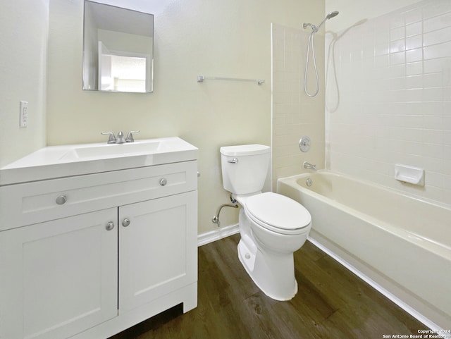 full bathroom with hardwood / wood-style flooring, vanity, toilet, and tiled shower / bath combo