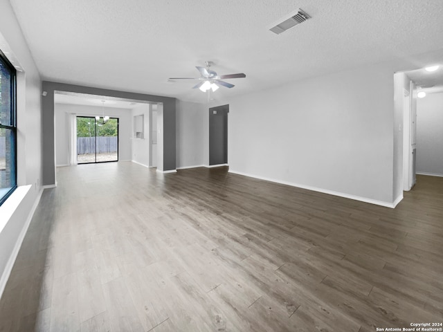 unfurnished living room with a textured ceiling, hardwood / wood-style flooring, and ceiling fan