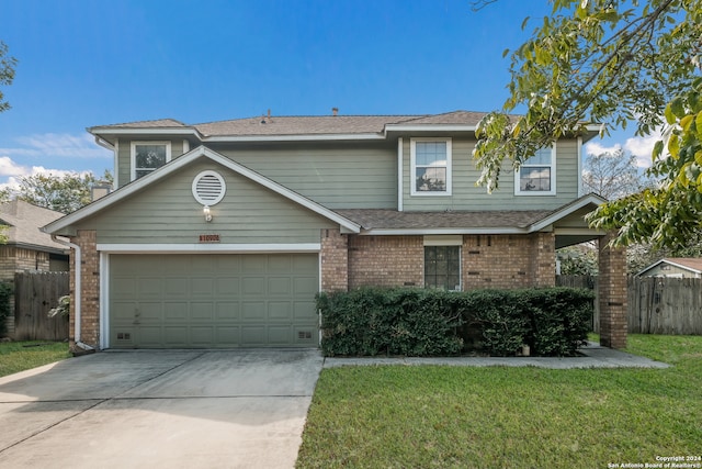 view of property with a garage and a front yard