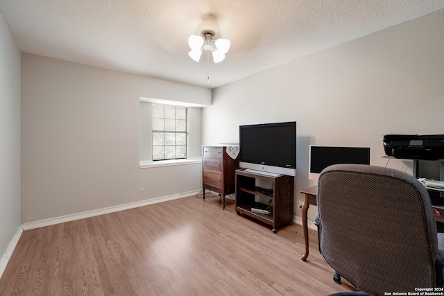 office featuring ceiling fan, a textured ceiling, and light hardwood / wood-style floors