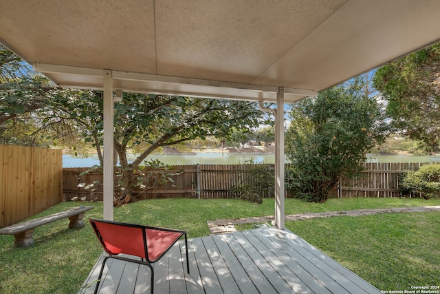 wooden deck featuring a yard and a water view