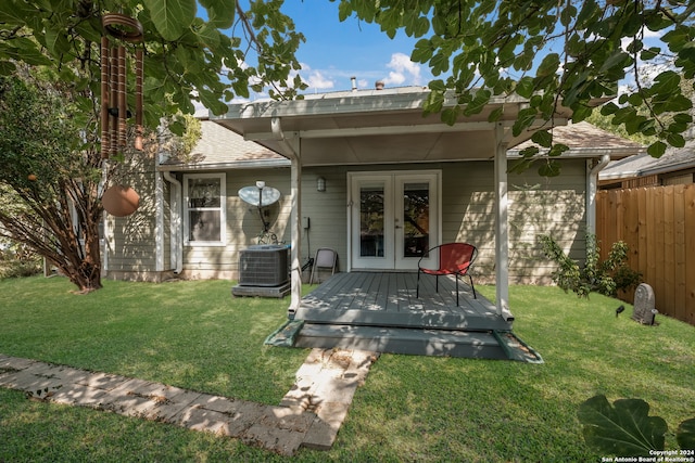 back of property featuring central AC unit, a lawn, and a deck