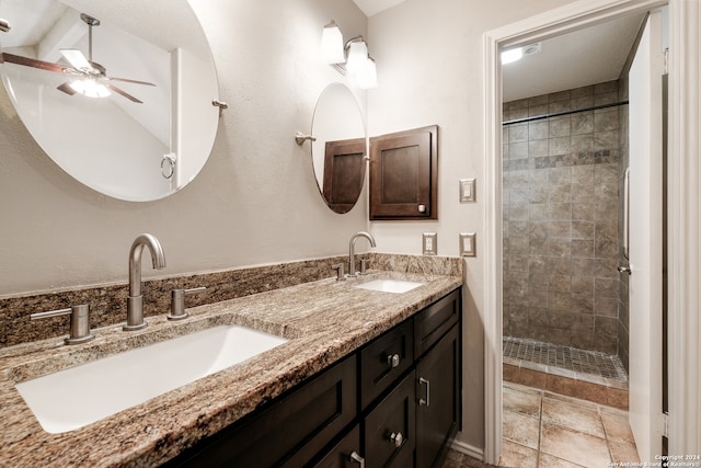 bathroom featuring vanity, ceiling fan, a tile shower, and lofted ceiling