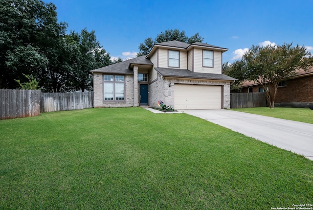 view of front of property with a garage and a front lawn