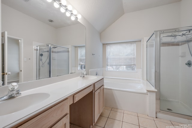 bathroom with vanity, tile patterned floors, shower with separate bathtub, and vaulted ceiling