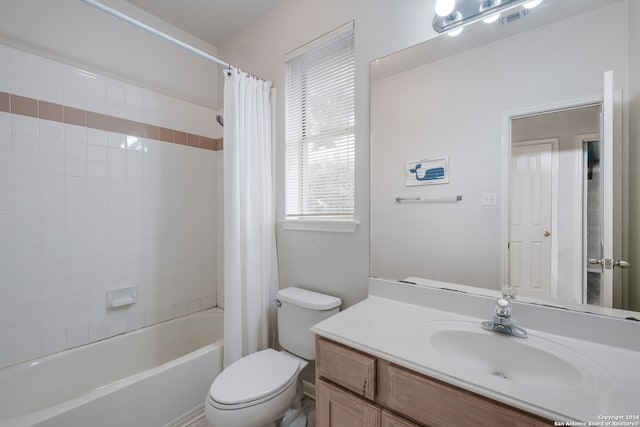 full bathroom featuring toilet, vanity, and shower / bathtub combination with curtain