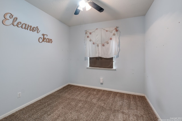 spare room featuring carpet flooring and ceiling fan