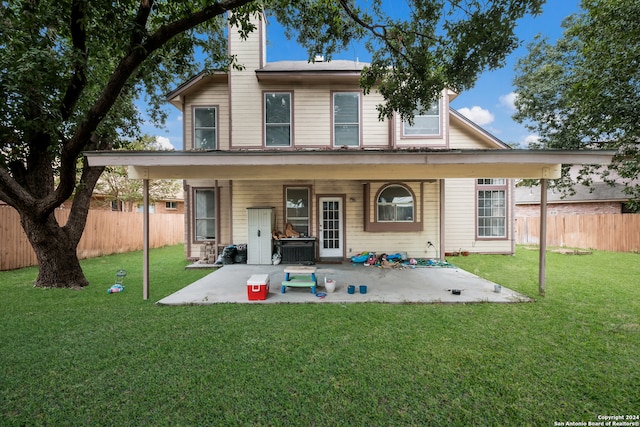 rear view of house featuring a lawn and a patio area