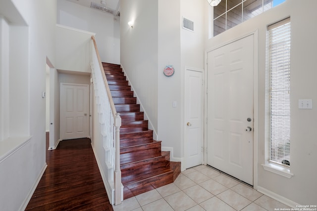 entrance foyer featuring a high ceiling and light hardwood / wood-style flooring