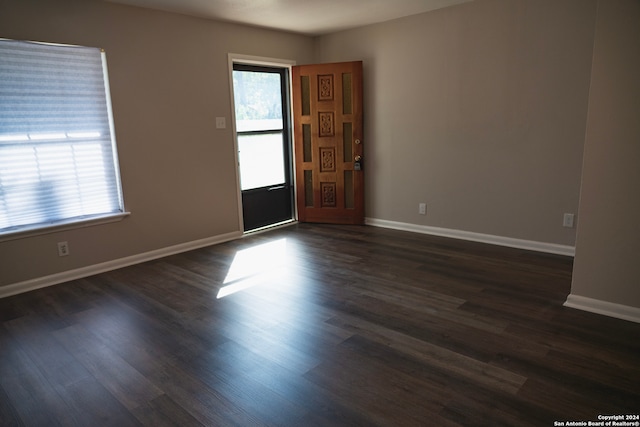 spare room with dark wood-type flooring