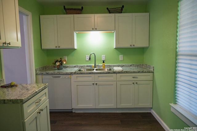 kitchen with light stone countertops, white cabinetry, dishwasher, dark wood-type flooring, and sink