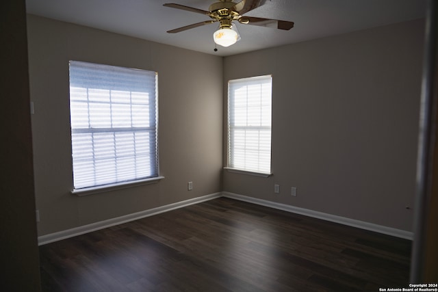 unfurnished room with ceiling fan and dark hardwood / wood-style floors