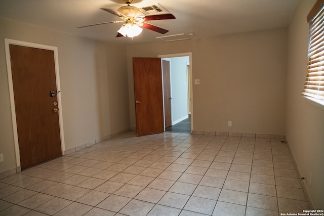 spare room featuring ceiling fan and light tile patterned floors