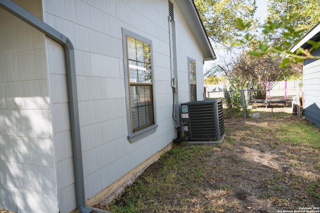 view of side of home with central AC