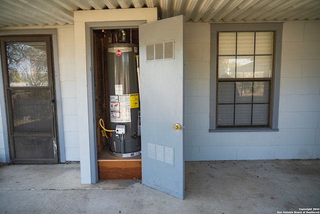 utility room featuring water heater